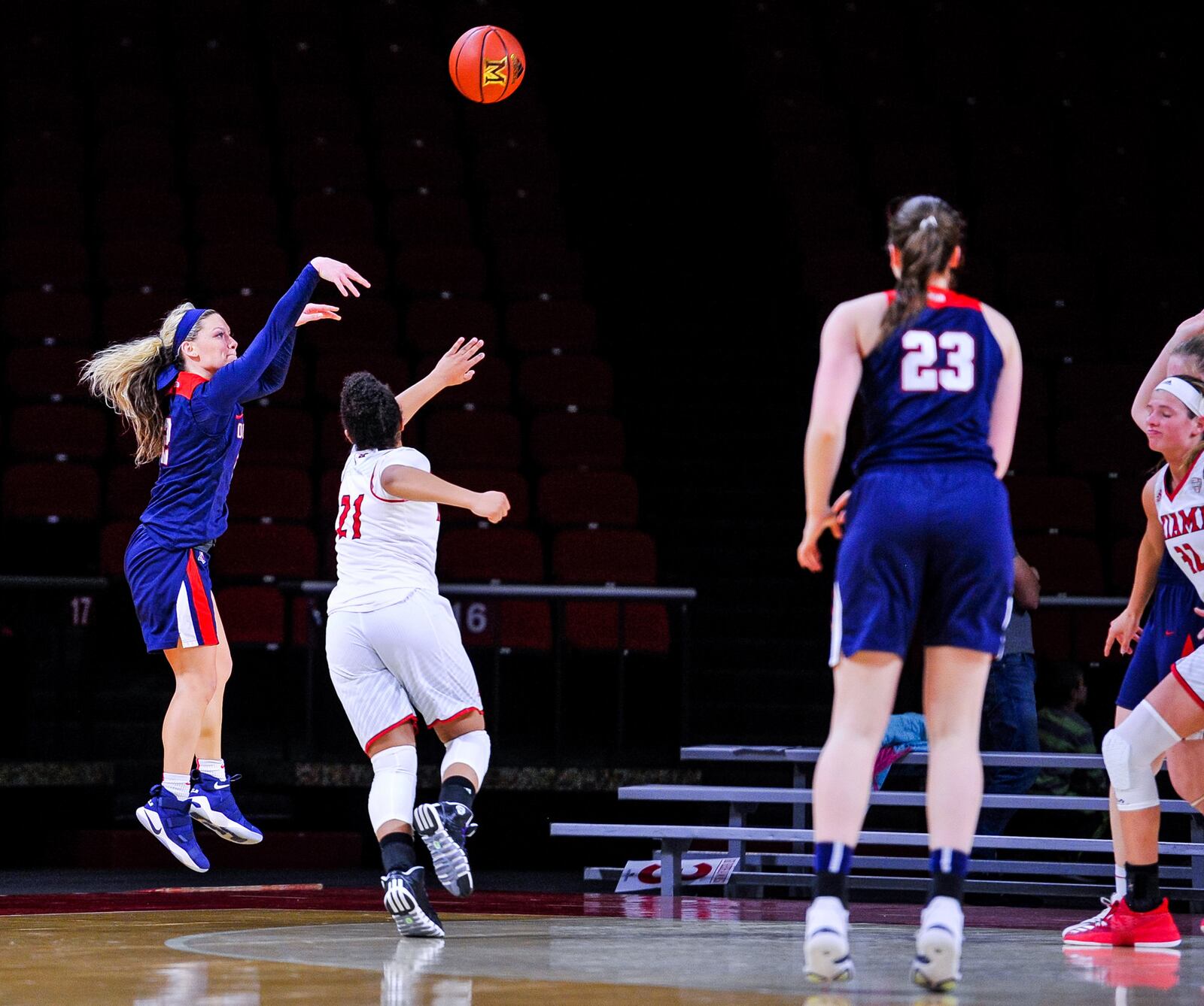 Duquesne’s Chassidy Omogrosso (2) fires a 3-pointer over Miami University’s Leah Purvis (21) during Thursday night’s WNIT game at Millett Hall in Oxford. NICK GRAHAM/STAFF