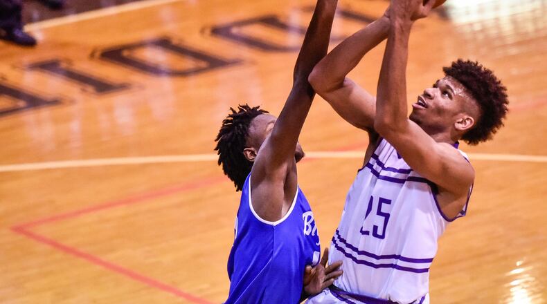 Middletown’s Jawunn Bailey puts up a shot while being defended by Hamilton’s Bryan Henderson during the final varsity game at Wade E. Miller Gym in Middletown on Dec. 8, 2017. Visiting Big Blue won 64-58. NICK GRAHAM/STAFF
