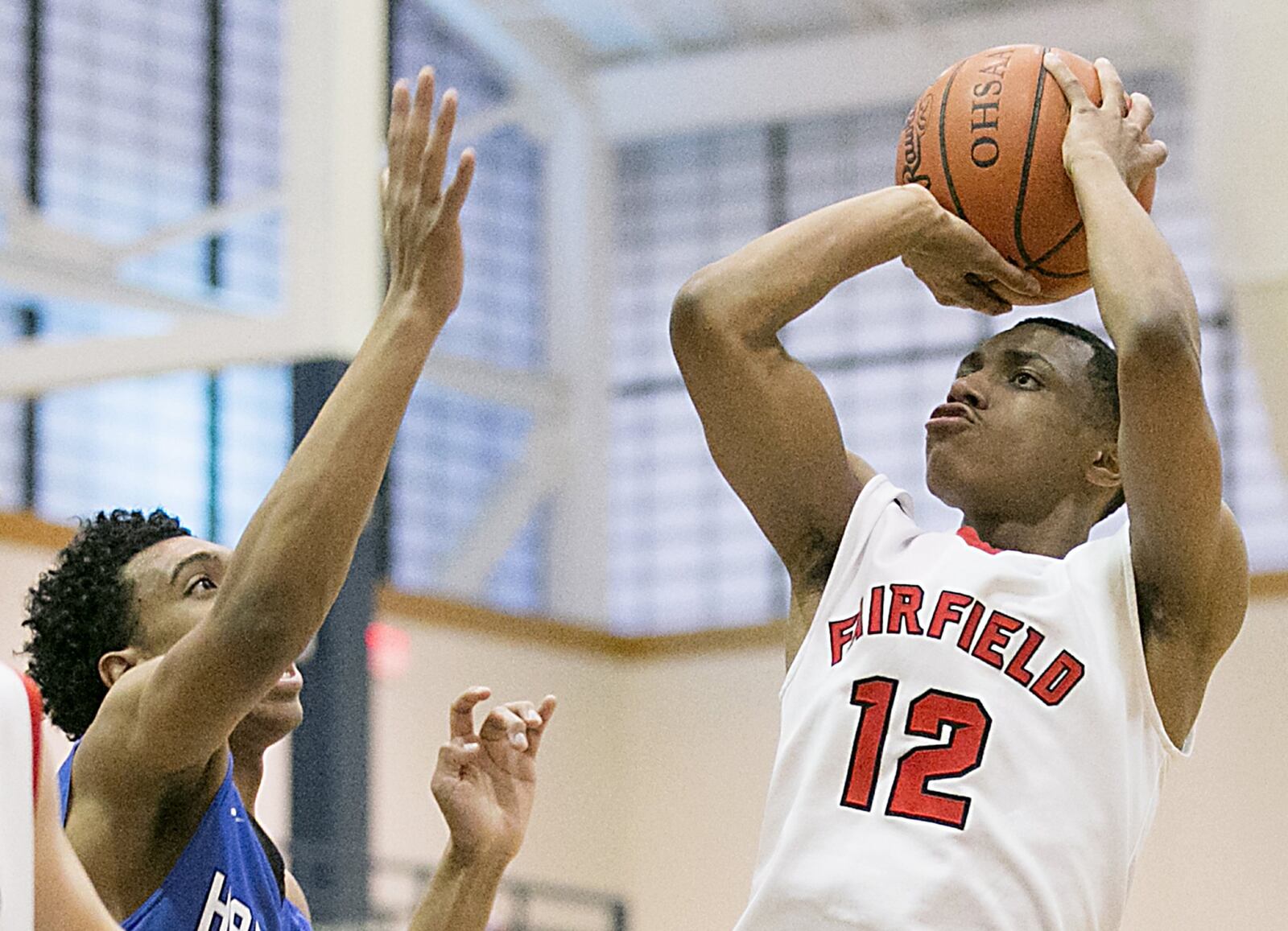 Fairfield guard Blake Spaulding shoots over Hamilton center Cameron Benson on Saturday night during the All-Butler County All-Star boys basketball game at the Hamilton Athletic Center. CONTRIBUTED PHOTO BY E.L. HUBBARD