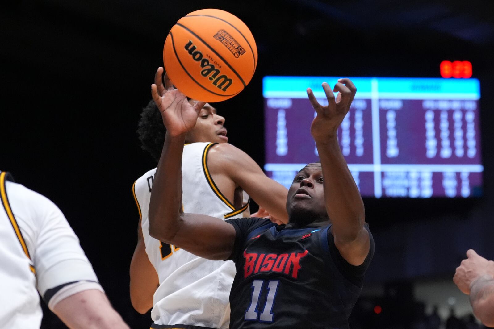 Howard guard Ose Okojie (11), center, competes for a rebound against UMBC forward Caden Diggs (11) during the second half in a First Four college basketball game in the NCAA Tournament, Tuesday, March 17, 2026, in Dayton, Ohio. (AP Photo/Kareem Elgazzar)