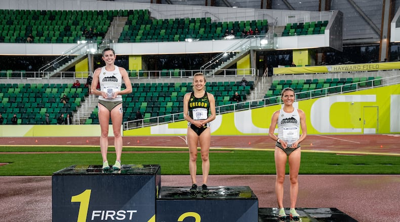 Alter graduate Abby Nichols, left, stands atop the podium at the Pac-12 track and field championships after winning the 10,000-meter race at Hayward Field in Eugene, Ore., on May 13, 2022. Photo by Tyler Davis/CU Athletics