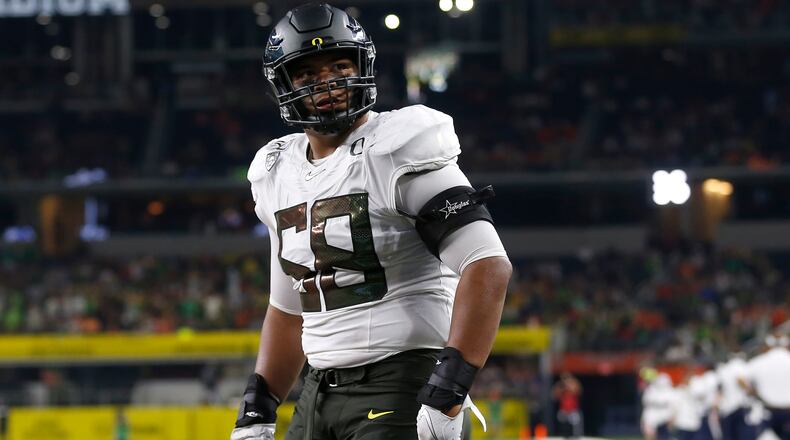 FILE - In this Aug. 31, 2019, file photo, Oregon offensive lineman Penei Sewell (58) looks on as Oregon plays Auburn in an NCAA college football game in Arlington, Texas. The last NFL event not impacted by the COVID-19 pandemic was the 2020 combine in Indianapolis. A year later, with the 2021 combine canceled, the league has released a list of players who would have merited invitations. From such high-profile quarterbacks as Clemson’s Trevor Lawrence and Ohio State’s Justin Fields to guys who sat out last season such as Oregon tackle Penei Sewell, there are 323 players from 100 schools. (AP Photo/Ron Jenkins, File)