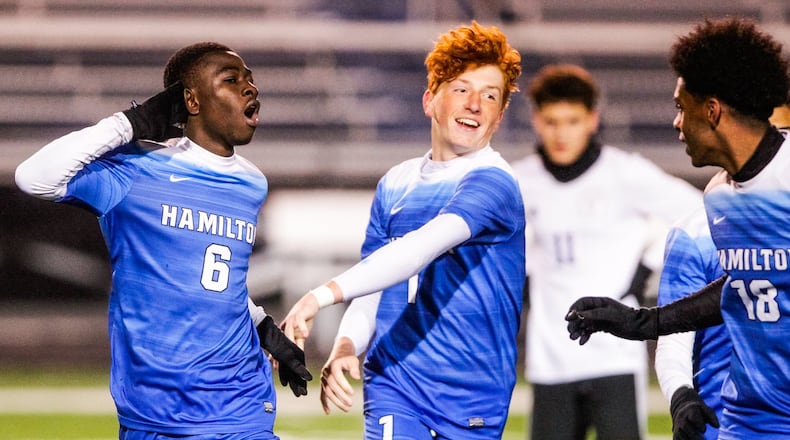Hamilton’s Kelvin Effah (6) celebrates a goal with teammate Cole Hamilton during their 4-2 Division I sectional win over visiting Middletown on Monday night at Virgil Schwarm Stadium in Hamilton. NICK GRAHAM/STAFF