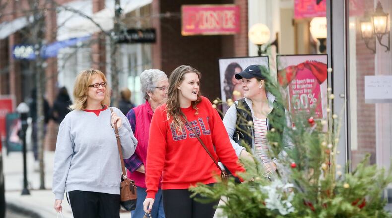 Shoppers walk through the streets at Liberty Center as they shop on Black Friday, Nov. 25, 2016. This weekend’s shopping could be the heaviest of the season. GREG LYNCH / STAFF