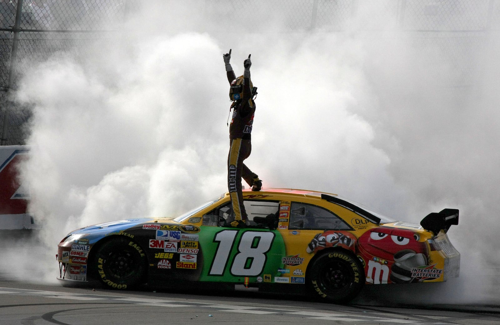 FILE - ASCAR driver Kyle Busch celebrates after winning the Aaron's 499 auto race at Talladega Superspeedway in Talladega, Ala., on April 27, 2008. (AP Photo/Ron Sanders, file)