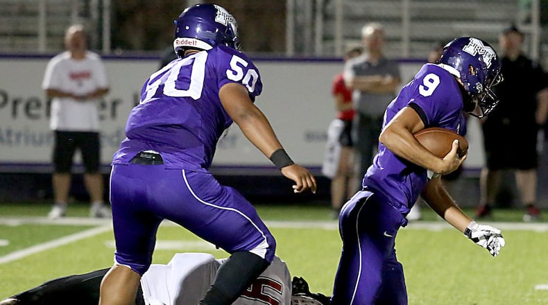 Middletown quarterback Zach Maloney is tackled by Colerain’s Daniel Bolden during their game at Barnitz Stadium in Middletown on Oct. 7, 2016. The visiting Cardinals won 47-8. CONTRIBUTED PHOTO BY E.L. HUBBARD