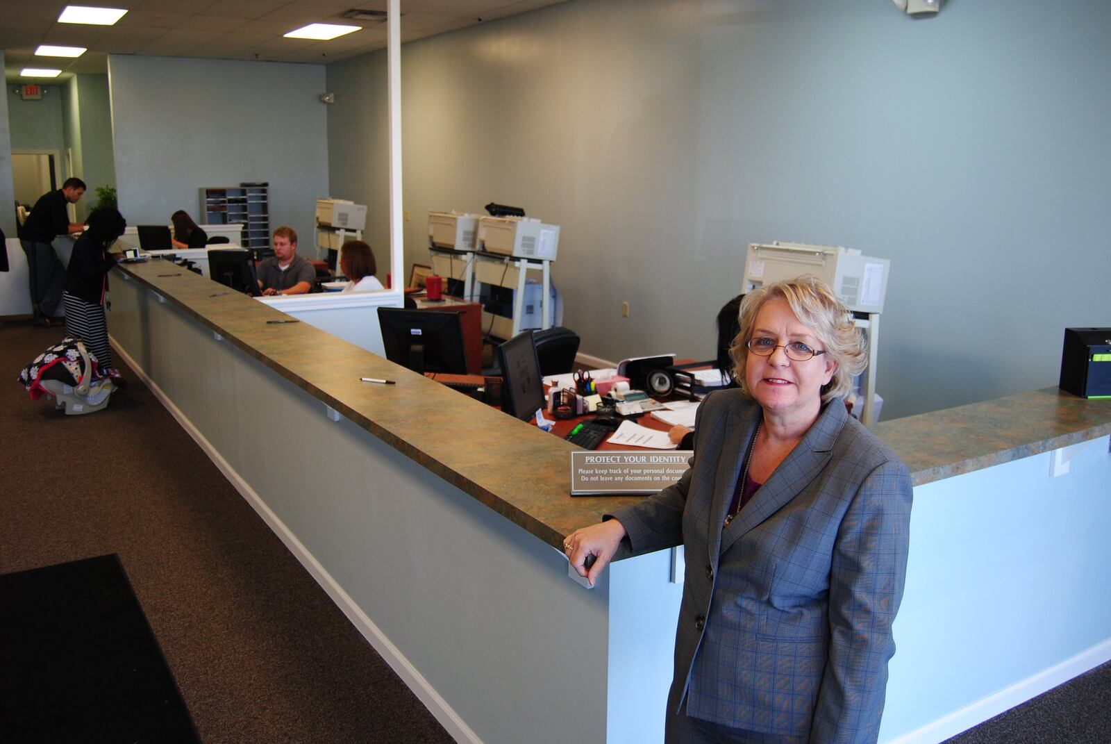 Butler County Clerk of Courts Mary Swain stands at the counter of the new Title Division office at 4872 Union Centre Pavilion Drive in West Chester Twp. on Monday, Oct. 27, 2014. The office, which processes vehicle titles, watercraft titles and passports applications, outgrew years ago the location that had operated on Smith Road. ERIC SCHWARTZBERG / STAFF