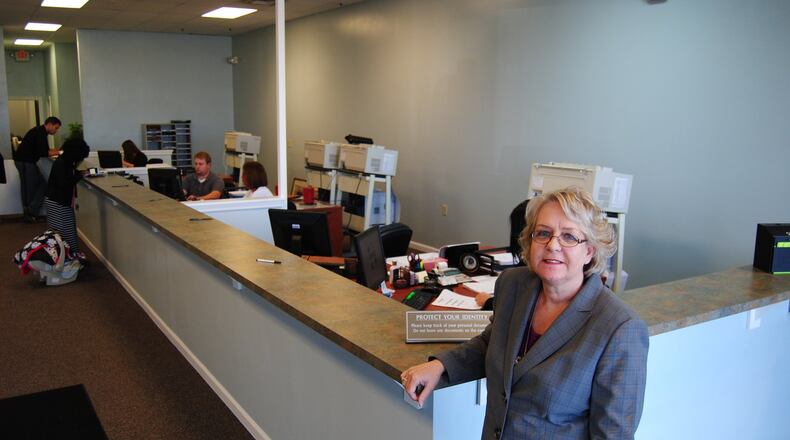Butler County Clerk of Courts Mary Swain stands at the counter of the new Title Division office at 4872 Union Centre Pavilion Drive in West Chester Twp. on Monday, Oct. 27, 2014. The office, which processes vehicle titles, watercraft titles and passports applications, outgrew years ago the location that had operated on Smith Road. ERIC SCHWARTZBERG / STAFF