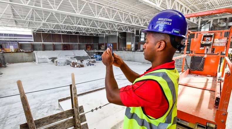 Middletown City Schools Superintendent Marlon Styles Jr. takes video of the new sports arena to post on social media during a tour of construction progress earlier this month at Middletown High School and the new Middletown Junior High School. NICK GRAHAM/STAFF