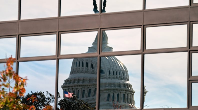 The Capitol dome is distorted by windows on the teamster's building, Tuesday, Nov. 4, 2025, in Washington. (AP Photo/Allison Robbert)