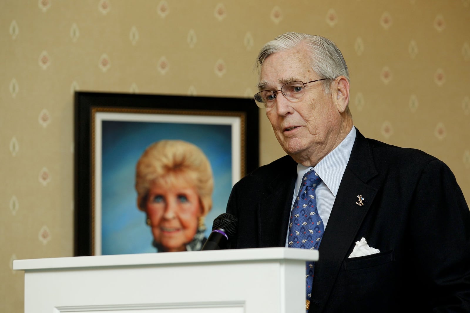 Pat Carruthers speaks next to a photo of his late wife Donna during a ribbon cutting ceremony and open house for the Donna Y. Carruthers Manor House at Berkeley Square Tuesday, Feb. 14, 2012, in Hamilton, Ohio. Staff photo by Nick Daggy