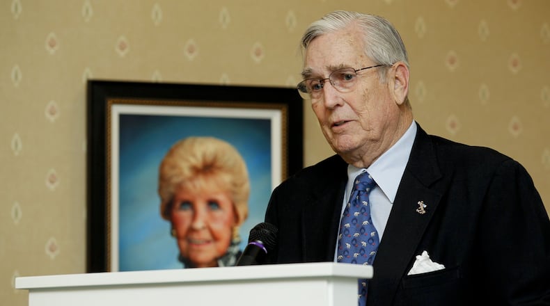 Pat Carruthers speaks next to a photo of his late wife Donna during a ribbon cutting ceremony and open house for the Donna Y. Carruthers Manor House at Berkeley Square Tuesday, Feb. 14, 2012, in Hamilton, Ohio. Staff photo by Nick Daggy