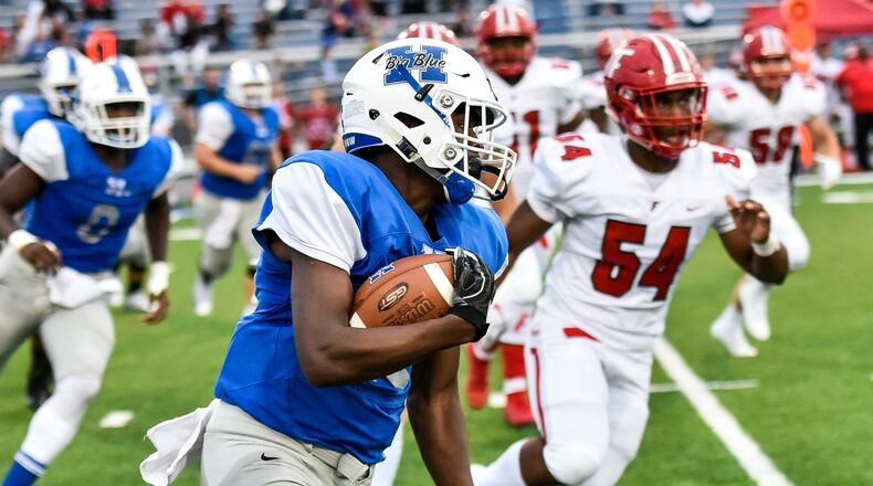 Hamilton’s Keyshawn Stephens carries the ball past Fairfield’s Del Thomas (54) on Sept. 7, 2018, during Fairfield’s 40-6 victory at Virgil Schwarm Stadium in Hamilton. NICK GRAHAM/STAFF