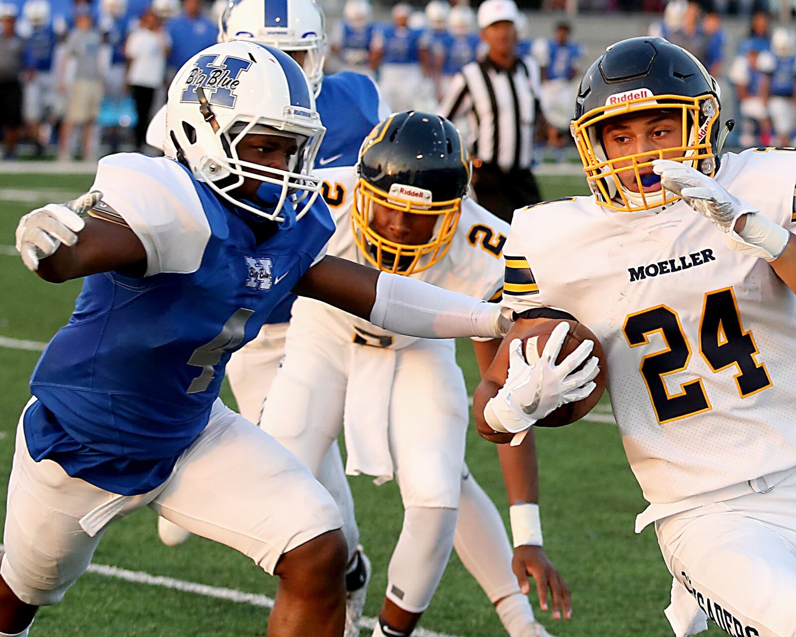 Hamilton’s Deon Tillery stops Moeller’s R.J. Khayo during their Skyline Chili Crosstown Showdown game at Virgil Schwarm Stadium in Hamilton on Saturday night. CONTRIBUTED PHOTO BY E.L. HUBBARD