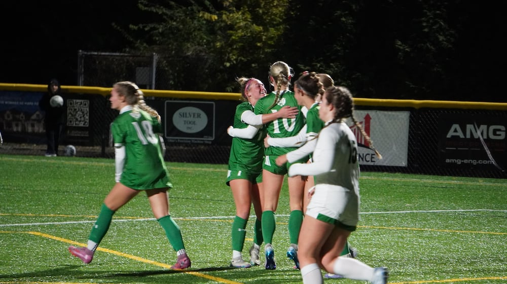 The Badin High School girls soccer celebrates after Lydia Kemper (10) scored a goal against McNicholas in a Division III regional semifinal on Tuesday at Centerville. CHRIS VOGT / CONTRIBUTED