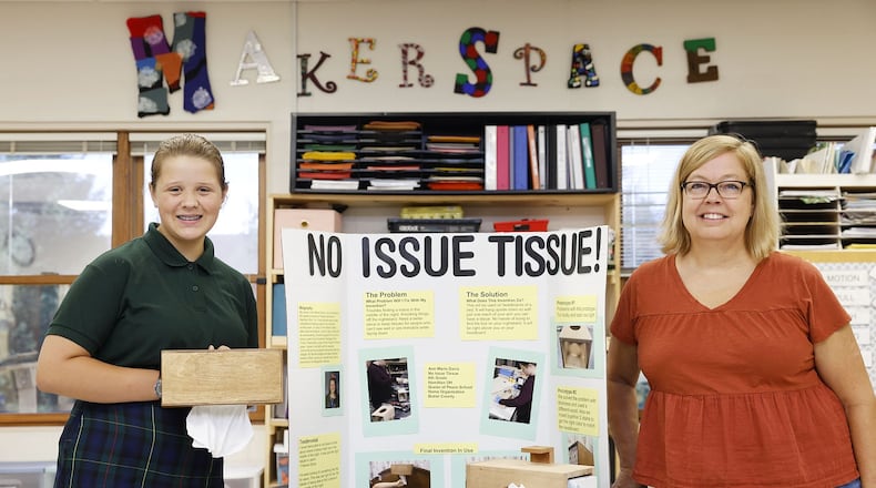 Ann Marie Davis, 12, won a state design award for her "No Issue Tissue" designed to make it easier for people with mobility issues to grab a tissue while in bed. The Queen of Peace student came up with the idea and created the project for her makerspace class taught by Melissa Moser,  right. NICK GRAHAM/STAFF