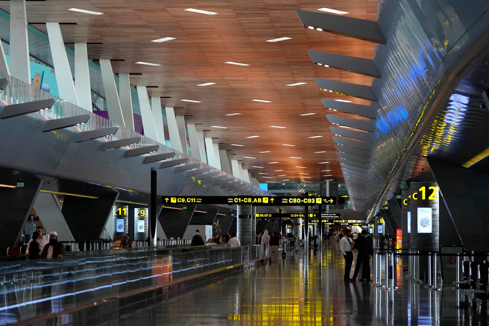 FILE - Passengers walk at Hamad International Airport in Doha, Qatar, Nov. 10, 2022. (AP Photo/Hassan Ammar, File)