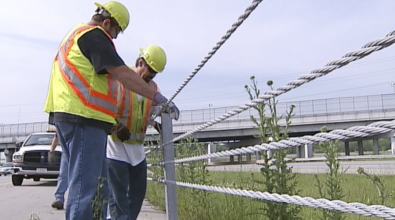 Ohio Department of Transportation workers repair safety cables on I-675 between U.S. 35 and North Fairfield Road on Monday, May 7. WHIO-TV PHOTO BY CHUCK HAMLIN