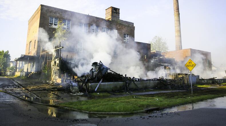 A large vacant warehouse burned to the ground and another sustained damage in the 600 block of Joe Nuxhall Boulevard in Hamilton, Monday, Oct. 8, 2018. GREG LYNCH / STAFF