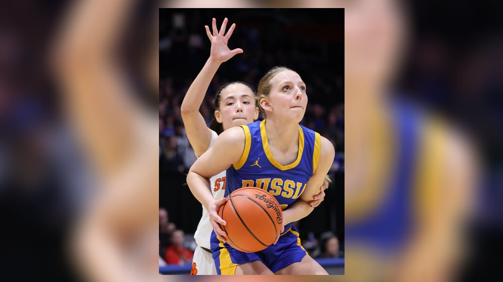Russia junior guard Hazel Francis shoots with pressure from Strasburg-Franklin's Sofia Secrest during the Division VII state final on Saturday, March 14 at University of Dayton Arena. BRYANT BILLING / STAFF