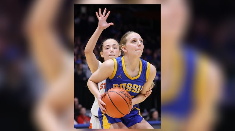 Russia junior guard Hazel Francis shoots with pressure from Strasburg-Franklin's Sofia Secrest during the Division VII state final on Saturday, March 14 at University of Dayton Arena. BRYANT BILLING / STAFF