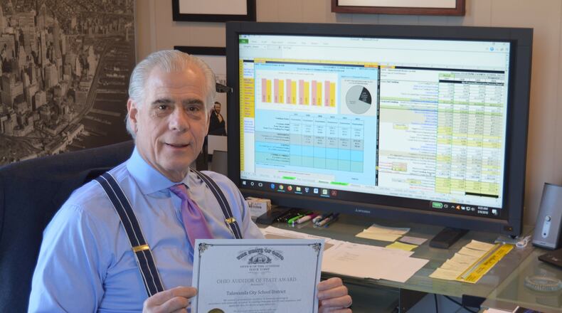 Talawanda Treasurer and CFO Mike Davis holds the district s Auditor of State Award received following a clean report of a financial audit in 2018. CONTRIBUTED/BOB RATTERMAN