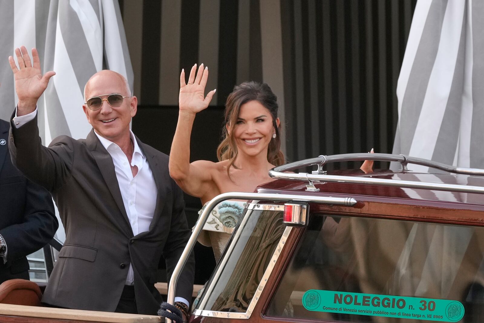 Jeff Bezos, left, and Lauren Sanchez leave a hotel for their pre wedding reception, in Venice, Italy, Thursday, June 26, 2025. (AP Photo/Luca Bruno)