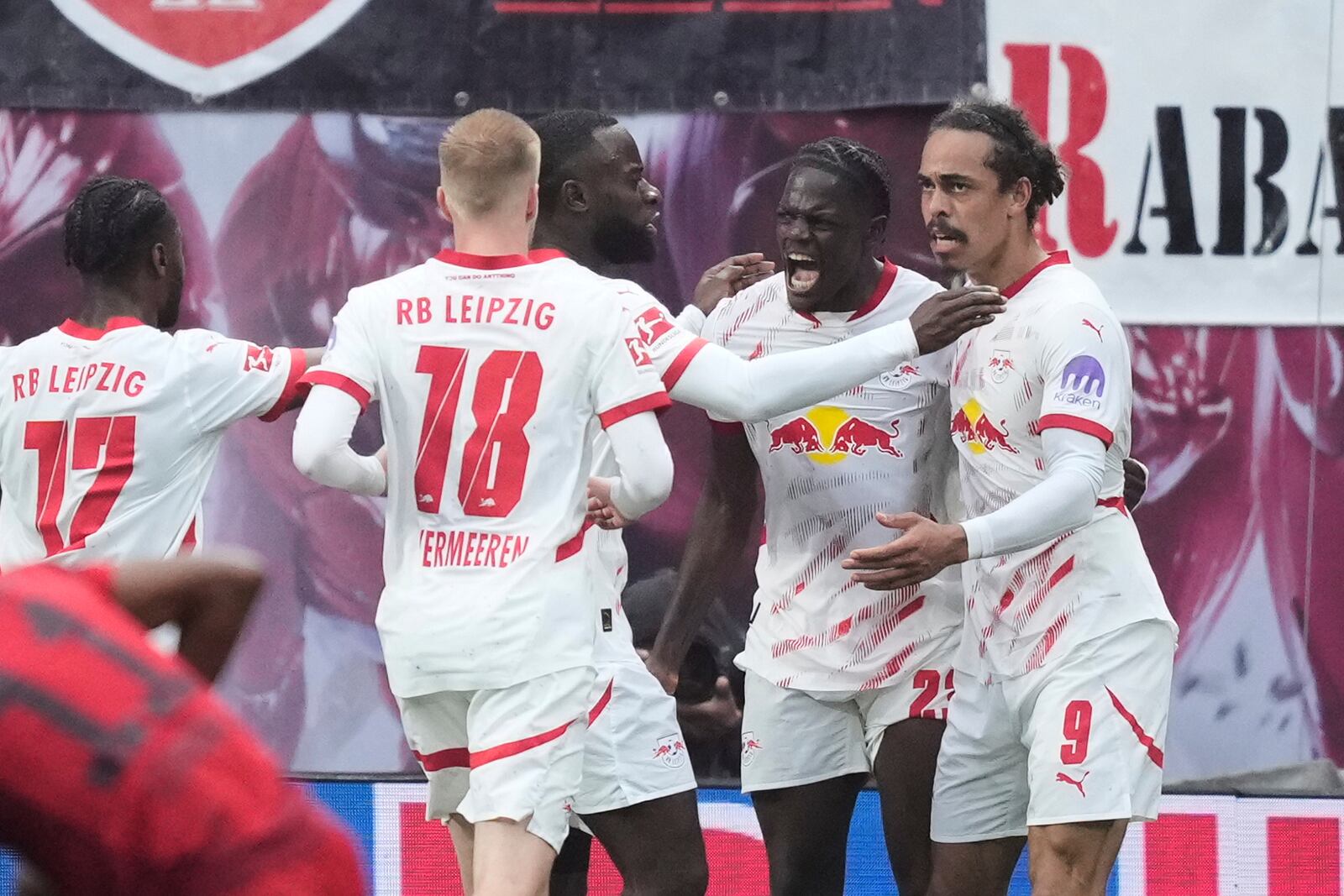 Leipzig's Yussuf Poulsen, right, celebrates with teammates after scoring his side's third goal during the German Bundesliga soccer match between RB Leipzig and FC Bayern Munich at the Red Bull Arena in Leipzig, Germany, Saturday, May 3, 2025. (AP Photo/Ebrahim Noroozi)