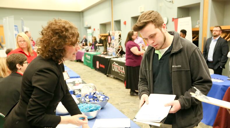 In this 2016 photo, Mark Kehl of Cincinnati talks with Joy Frey of Barclaycard during the Miami University Regional Butler County Job Fair. This year’s job fair will take place Wednesday, April 12. GREG LYNCH / STAFF