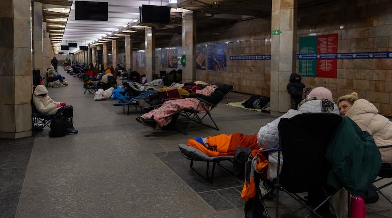 People take shelter in a metro station, being used as a bomb shelter, during a Russian drones attack in Kyiv, Ukraine, Tuesday, Feb. 3, 2026. (AP Photo/Alex Babenko)