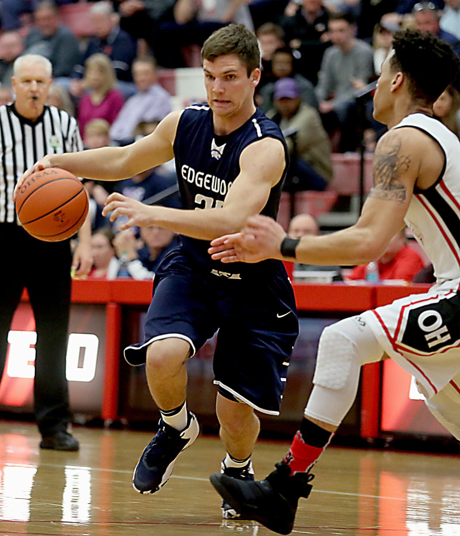 Edgewood forward Jake Paulsen tries to mave past Oak Hills guard Ryan Batte on Tuesday night during Division I sectional action at Fairfield Arena. CONTRIBUTED PHOTO BY E.L. HUBBARD