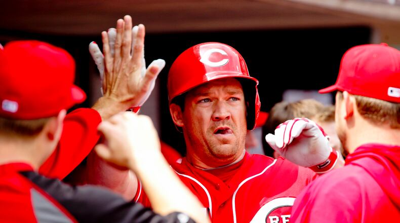 Scott Rolen high-fives his teammates after hitting in a home run in Thursday’s game against the Giants April 26, 2012, at Great American Ball Park in Cincinnati, Ohio. Staff photo by Nick Daggy
