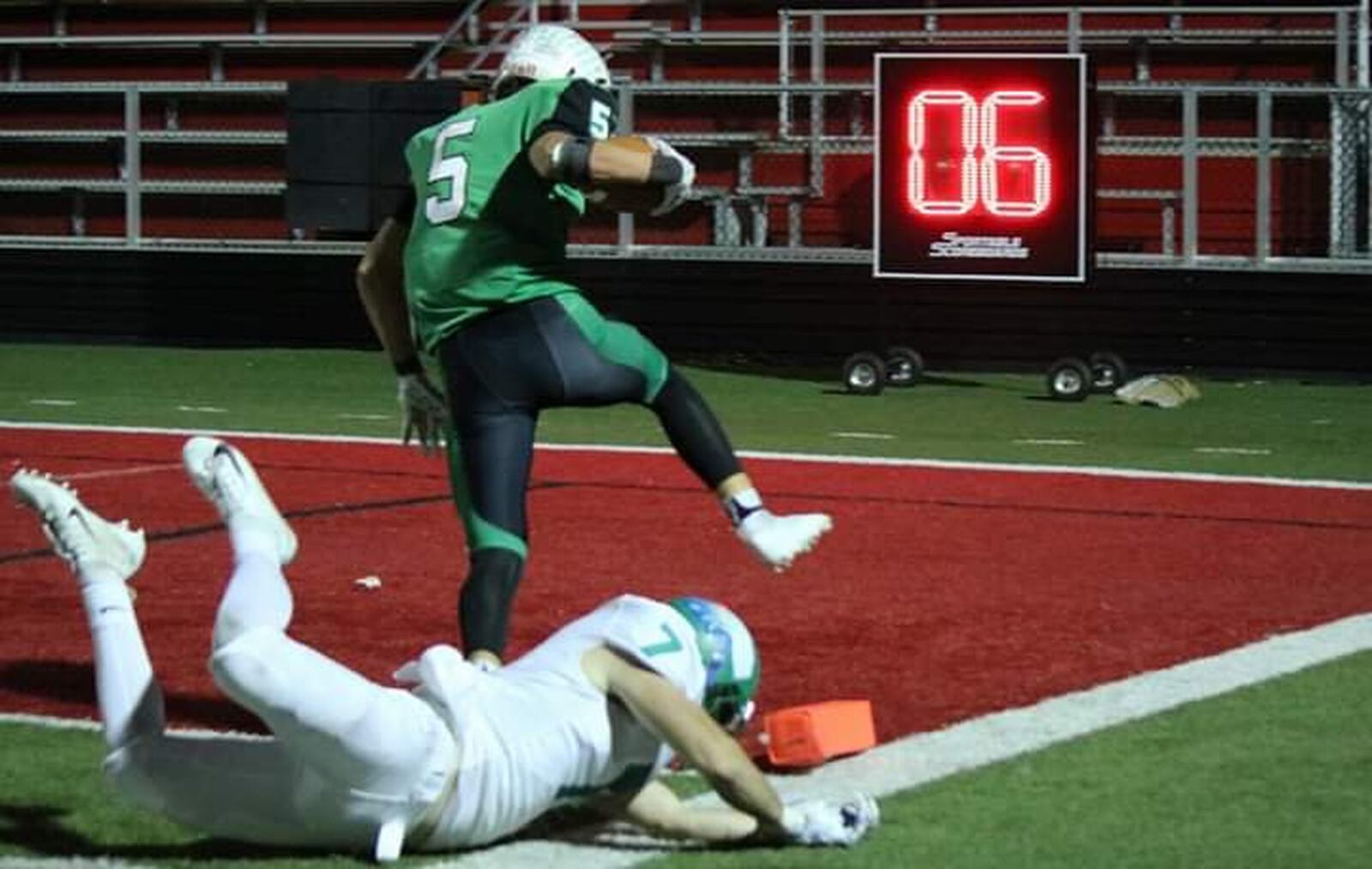 Badin’s Marshall Flaig (5) gets past Chaminade Julienne’s Brendan Kadel (7) for a touchdown Friday night at Fairfield Stadium in Fairfield. The play was a 20-yard pass from Zach Switzer as the Rams won 38-21. CONTRIBUTED PHOTO BY TERRI ADAMS