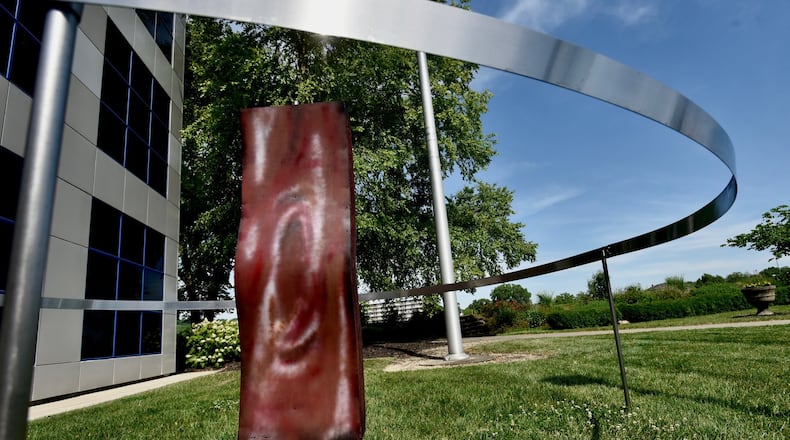 The sculpture, “6 Feet from Kevin’s Bacon” now can be seen on the lawn north of the Fitton Center for Creative Arts, after initially being installed by Hamilton sculptor Nick Bauer. NICK GRAHAM/STAFF