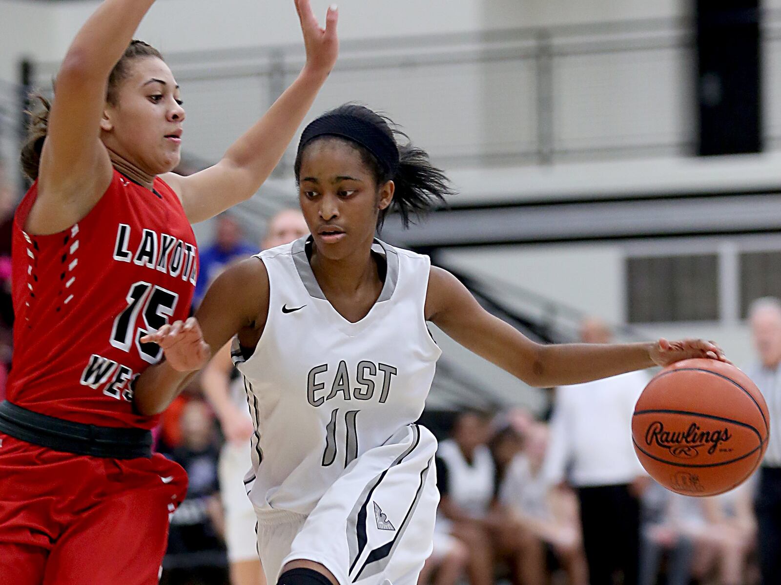 Lakota East guard Shaniyah Reese is defended by Lakota West guard Sarah Jones on Wednesday night at East. CONTRIBUTED PHOTO BY E.L. HUBBARD