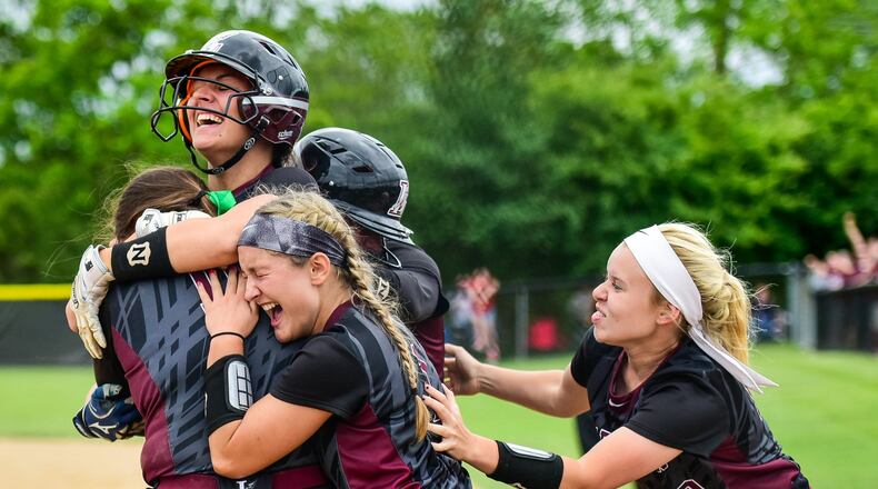Lebanon celebrates its game-winning run in a 14-13 victory over Lakota West in a Division I regional semifinal at Centerville on May 24, 2017. NICK GRAHAM/STAFF