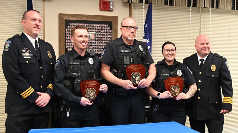 Ross Twp. police officers Shawn Stamper, Matt Hale and Madison Stoeppel (center three, from left) were honored by Butler County Prosecutor Mike Gmoser on Tuesday, April 15, 2025, with the Meritorious Service Award for an October accident. MICHAEL D. PITMAN/STAFF