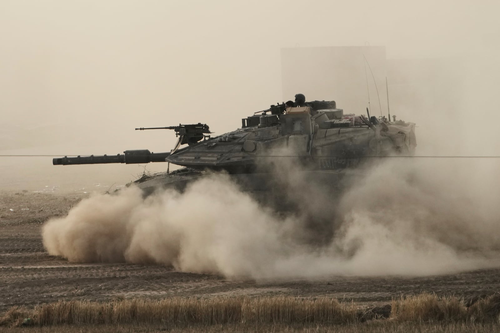An Israeli tank moves in a staging area in southern Israel, near the border with Gaza, Friday, May 16, 2025. (AP Photo/Maya Alleruzzo)