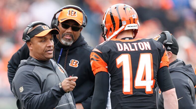 Cincinnati Bengals offensive coordinator Hue Jackson speaks with quarterback Andy Dalton (14) in the first half of an NFL football game against the St. Louis Rams, Sunday, Nov. 29, 2015, in Cincinnati. (AP Photo/Frank Victores)