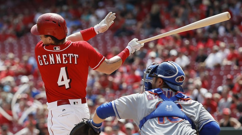 Scooter Gennett hits an RBI double off Mets pitcher Jacob deGrom in the fifth inning Thursday at Great American Ball Park. Gennett also homered as the Reds won, 7-2, to secure their first winning month of the season. (AP Photo/John Minchillo)