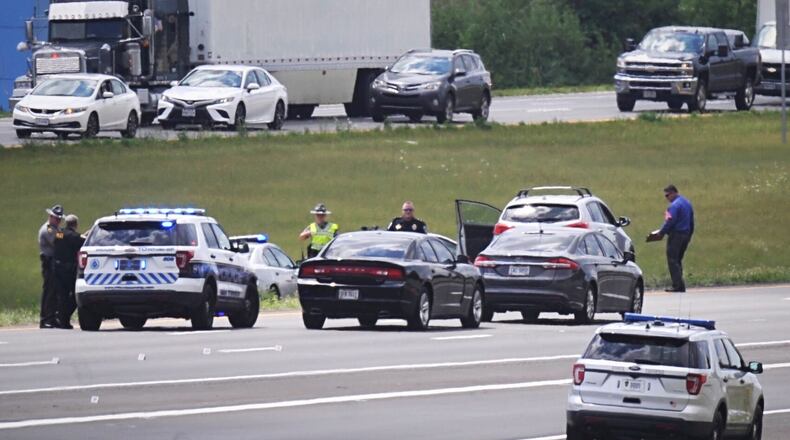 Investigators respond to a deadly shooting on Interstate 75 south near Austin Boulevard in Miami Twp. that happened around noon Monday, July 27, 2020. MARSHALL GORBY / STAFF