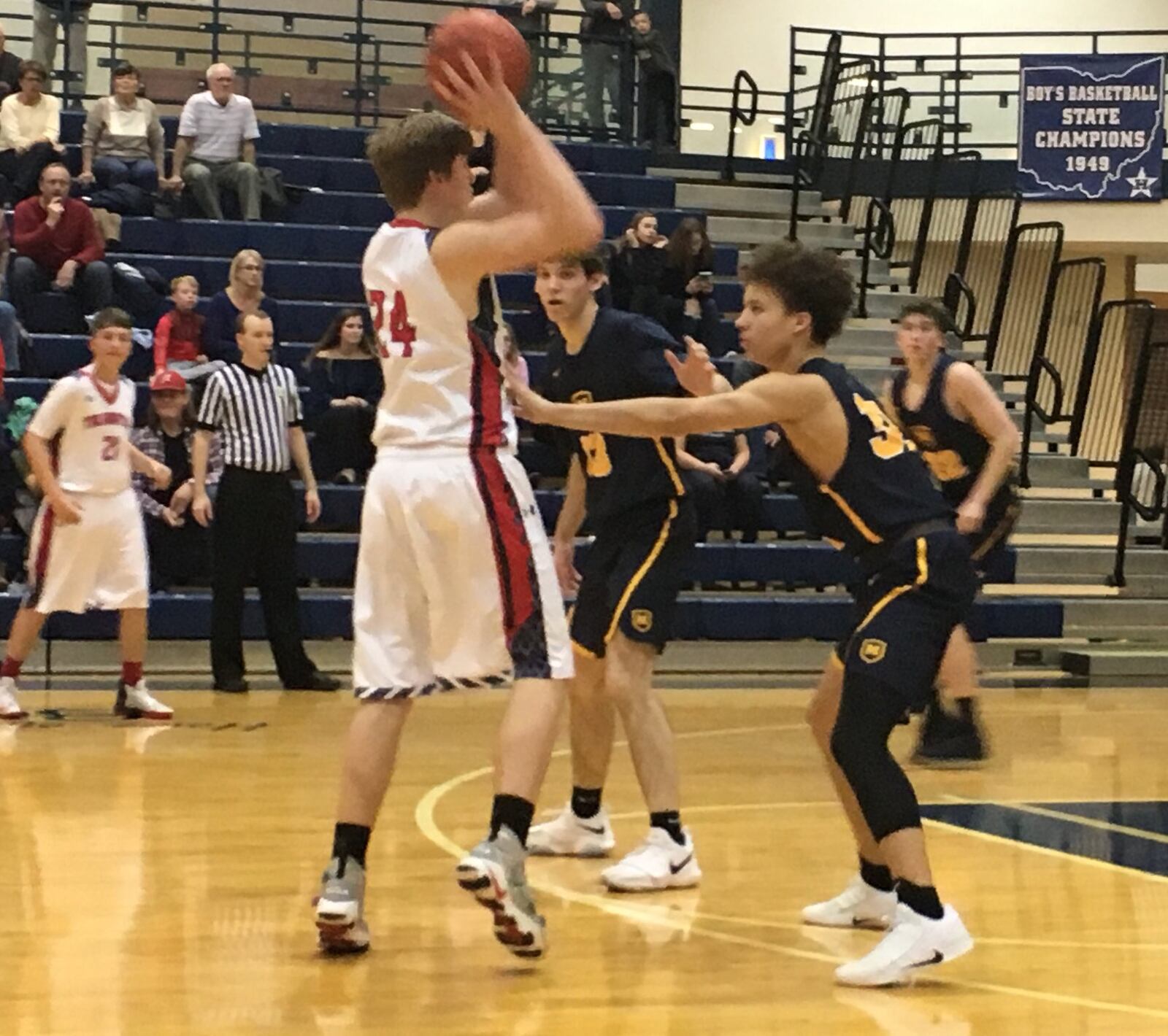 Talawanda’s Jonathan Richter (24) looks to make a pass over Moeller’s Max Land (32) during Wednesday night’s Division I sectional game at the Hamilton Athletic Center. RICK CASSANO/STAFF