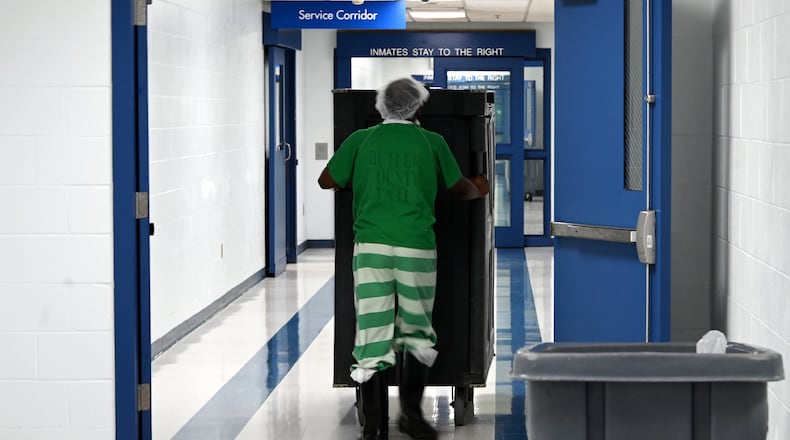 Butler County Sheriff Richard Jones has taken a hard stance on immigration since taking office more than two decades ago. He had 10 deputies credentialed to serve as ICE agents in the county, and said he plans to have more deputies eventually go through the training. Pictured is an inmate on Wednesday, July 9, 2025, pushing a cart of food in the hallway at the Butler County Jail. MICHAEL D. PITMAN/STAFF