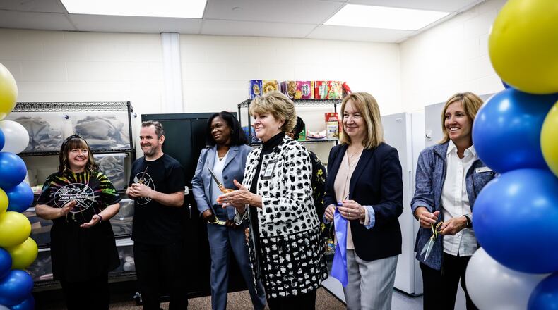 From the right, Molly Lunne, Liz Swanson, Elizabeth Lolli, Wyetta Hayden and Dr. Terress Monroe cut the ribbon on a new food pantry at Edison Elementary School on Broadway St. Wednesday 18, 2022. Dayton Public Schools in partnership with the Foodbank, Miami Valley Meals, Hall Hunger Initiative, Five Rivers Metroparks and the YMCA helped initiate the food pantry. JIM NOELKER/STAFF