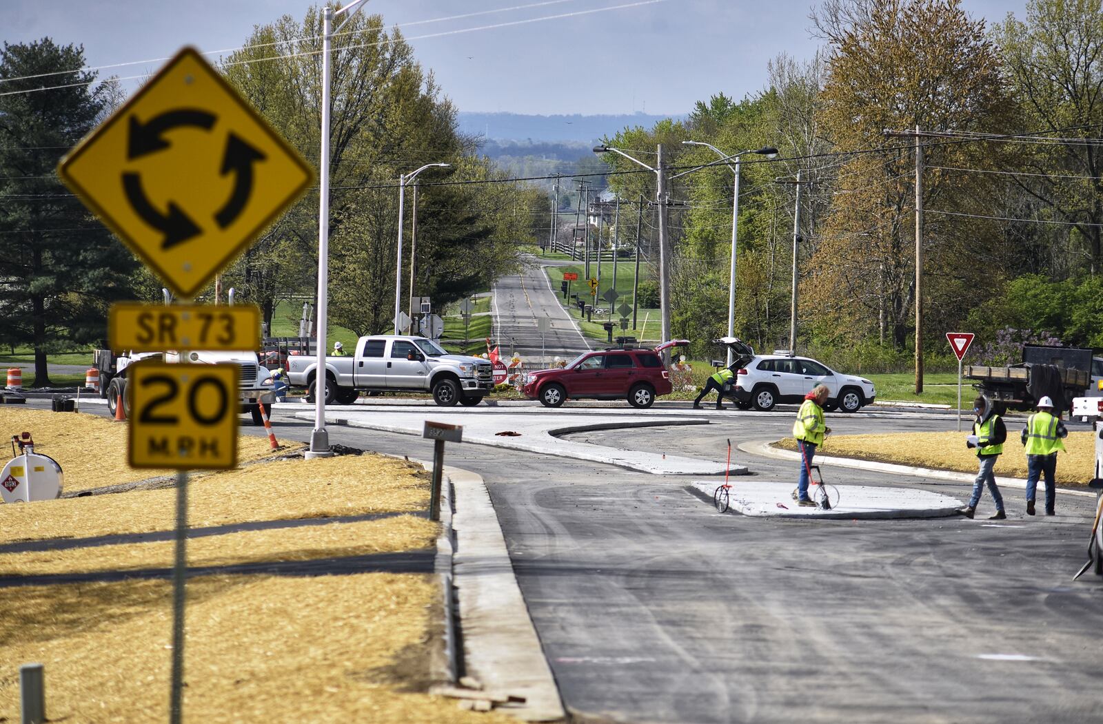 Construction crews put finishing touches on the roundabout at Ohio 73 and Jacksonburg Road Thursday, April 22. The roundabout is scheduled to open Friday. Federal funds helped pay for the project. NICK GRAHAM / STAFF