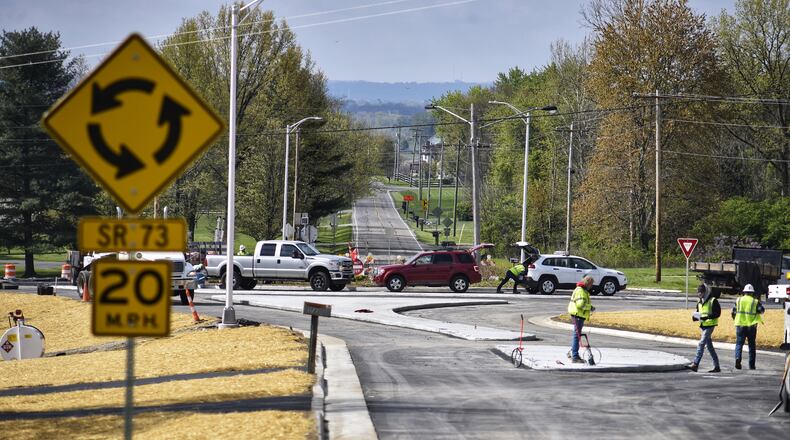 Construction crews put finishing touches on the roundabout at Ohio 73 and Jacksonburg Road Thursday, April 22. The roundabout is scheduled to open Friday. Federal funds helped pay for the project. NICK GRAHAM / STAFF