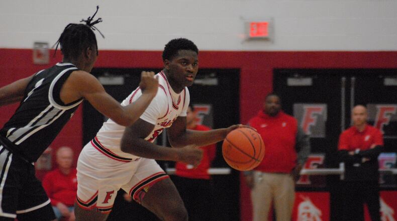 Fairfield's Ray Coney (5) is guarded by Lakota East's (1) Lebron Bennie-Powell during Friday night's game at Fairfield. Chris Vogt/CONTRIBUTED