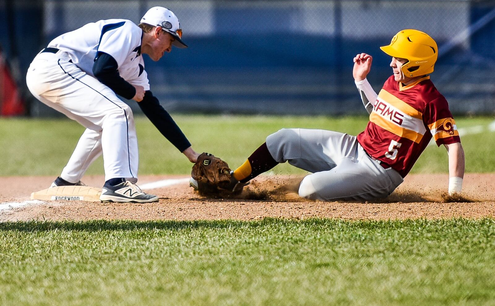 Edgewood’s Isaac Haskell tags out Brock Tatum of Ross at third base during Wednesday’s game in St. Clair Township. NICK GRAHAM/STAFF