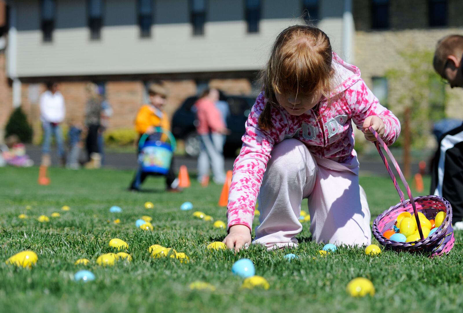 Danielle White, 7, of Hamilton, picks up eggs during the Easter Egg Hunt at Hamilton Church of God on Saturday, April 7, 2012. Staff photo by Samantha Grier