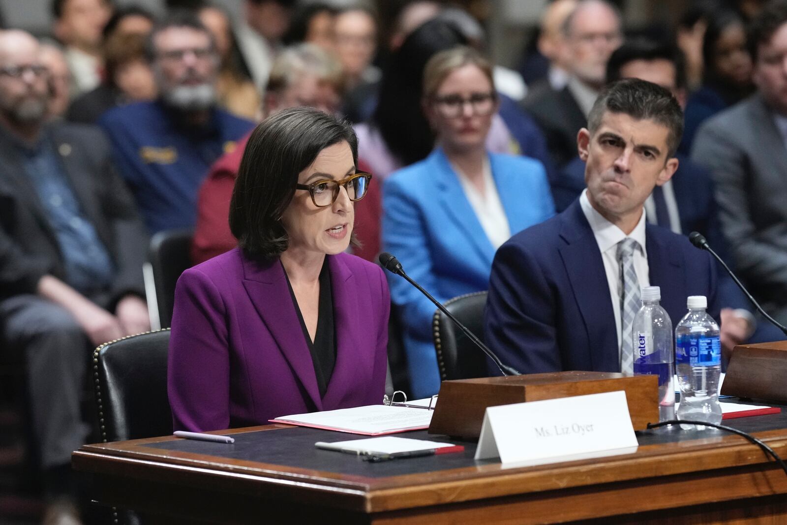 Former Justice Department attorneys Liz Oyer, left, and Ryan Crosswell participate in a hearing on the Justice Department on Capitol Hill in Washington, Monday, April 7, 2025. (AP Photo/J. Scott Applewhite)